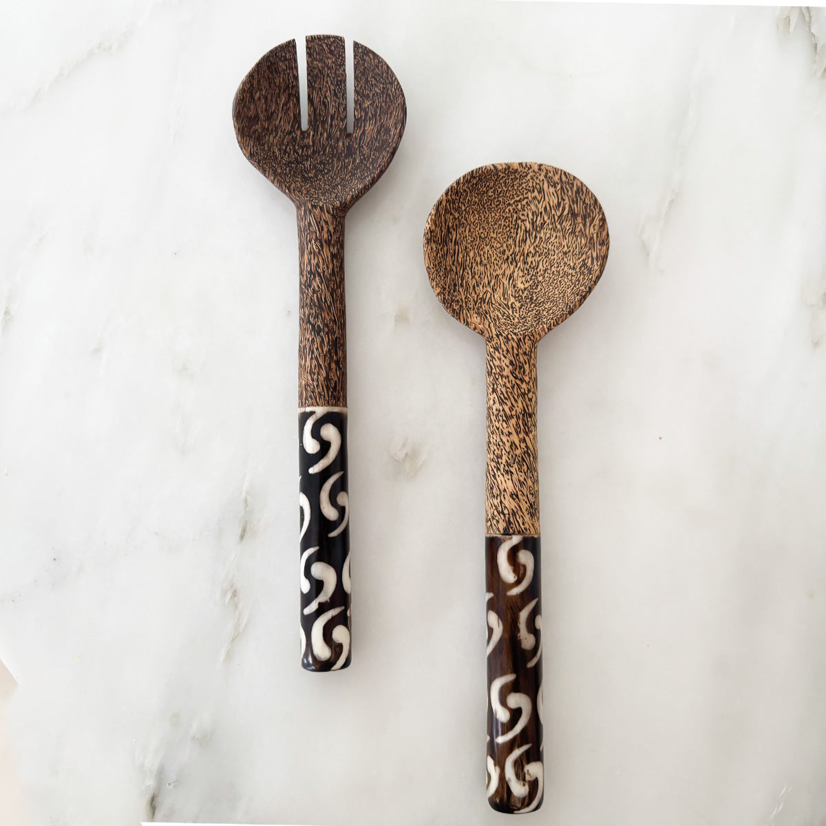 Crafted from durable black palm wood, these salad servers feature a thick handle for a comfortable grip and bold contrast to enhance your dining experience. Perfect for serving or as a unique gift for any occasion. Elevate your dining table with these stylish and functional servers.