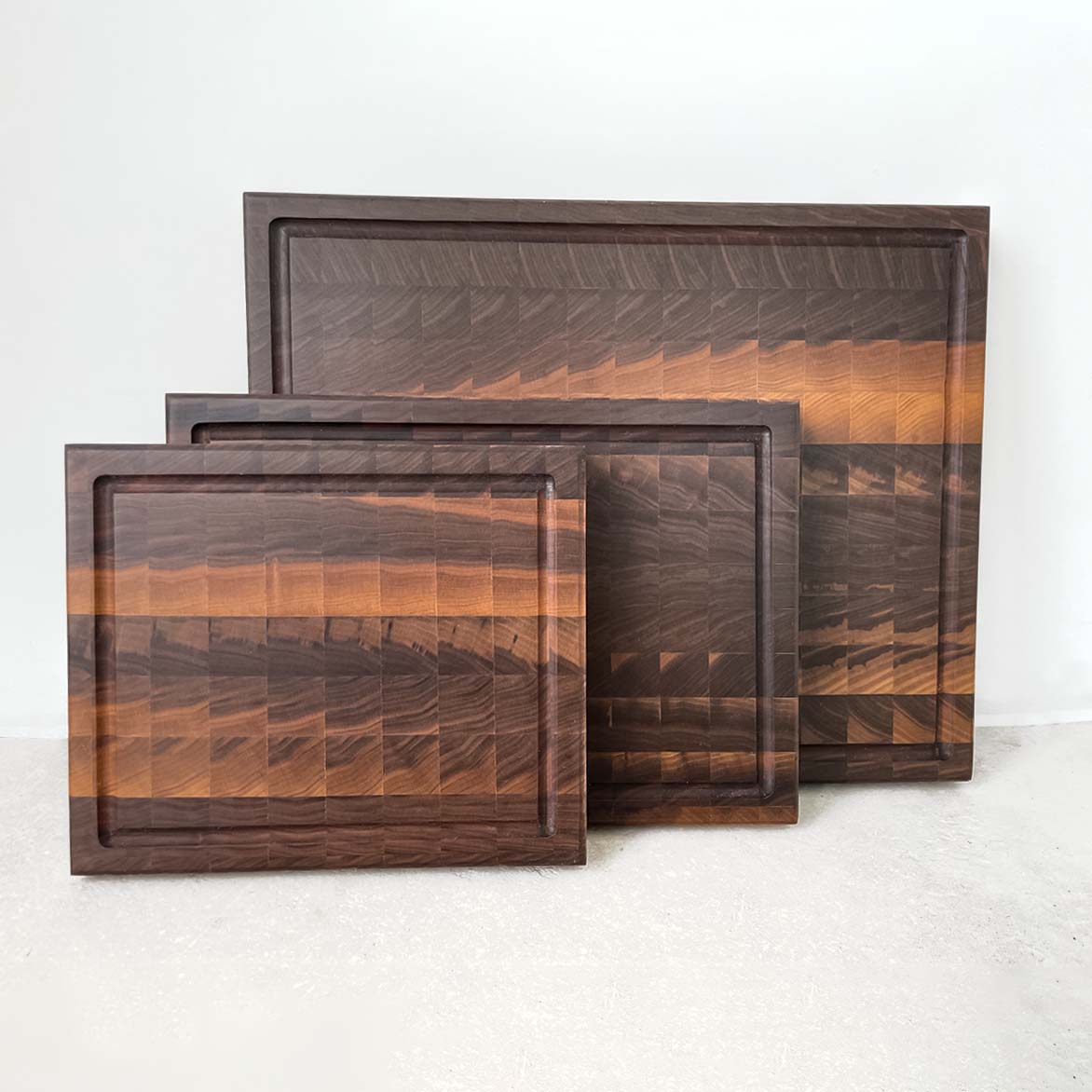 The Hawthorne set of 3 walnut end grain cutting boards is a best seller. The boards feature an arrowhead pattern providing an attractive and functional surface to cut and chop on. The end grain construction is gentle on knives and makes The Hawthorne a favourite among chefs. A staple kitchen accessory.